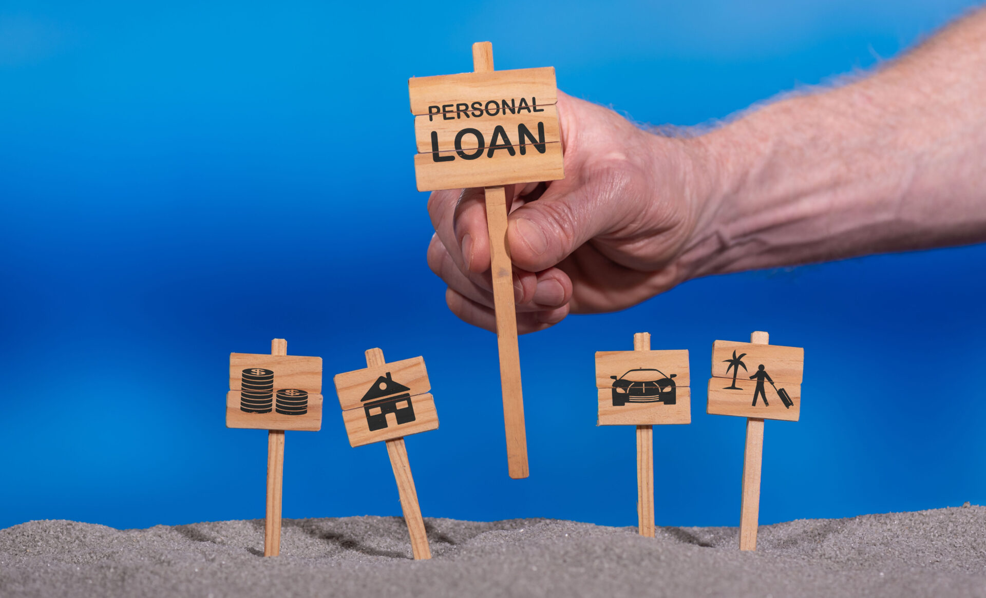 Concept of personal loan with icons on wooden signs